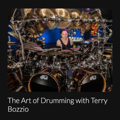DC-Entertainment _ Terry Bozzio Image of Terry Bozzio sitting at a large drum kit.